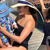 Eva Longoria shows off baby boy while relaxing poolside in elegant black one-piece bathing suit