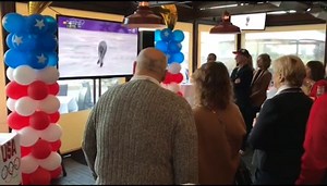 Brian Boitano (in hat) watches the 2018 Winter Olympics