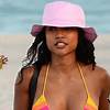 Karrueche Tran turns up the heat as she shows off her flawless figure in rainbow striped bikini