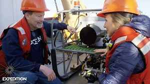 Expedition scientist Bob shows camera to Alexandra Cousteau