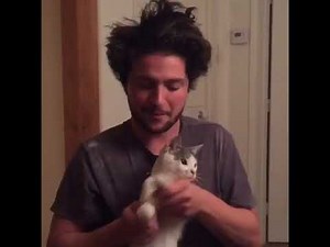 Thomas Mcdonell playing with cat